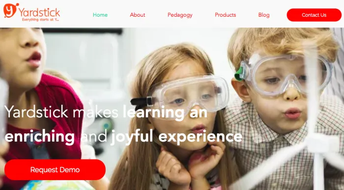 Three children keenly looking at something and yardstick written in red on top left