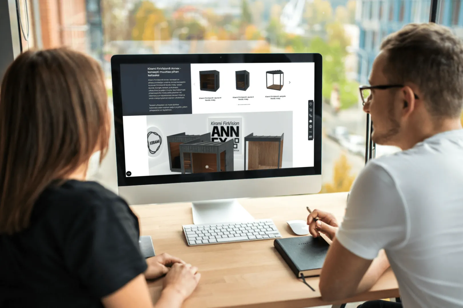 Two people looking at Kirami FinVision® Annex concept on a desktop screen in a modern office setting.