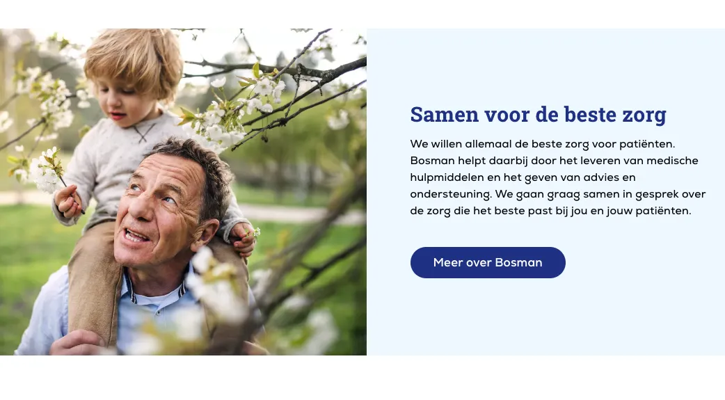 Man with child on his neck walking under blossom tree