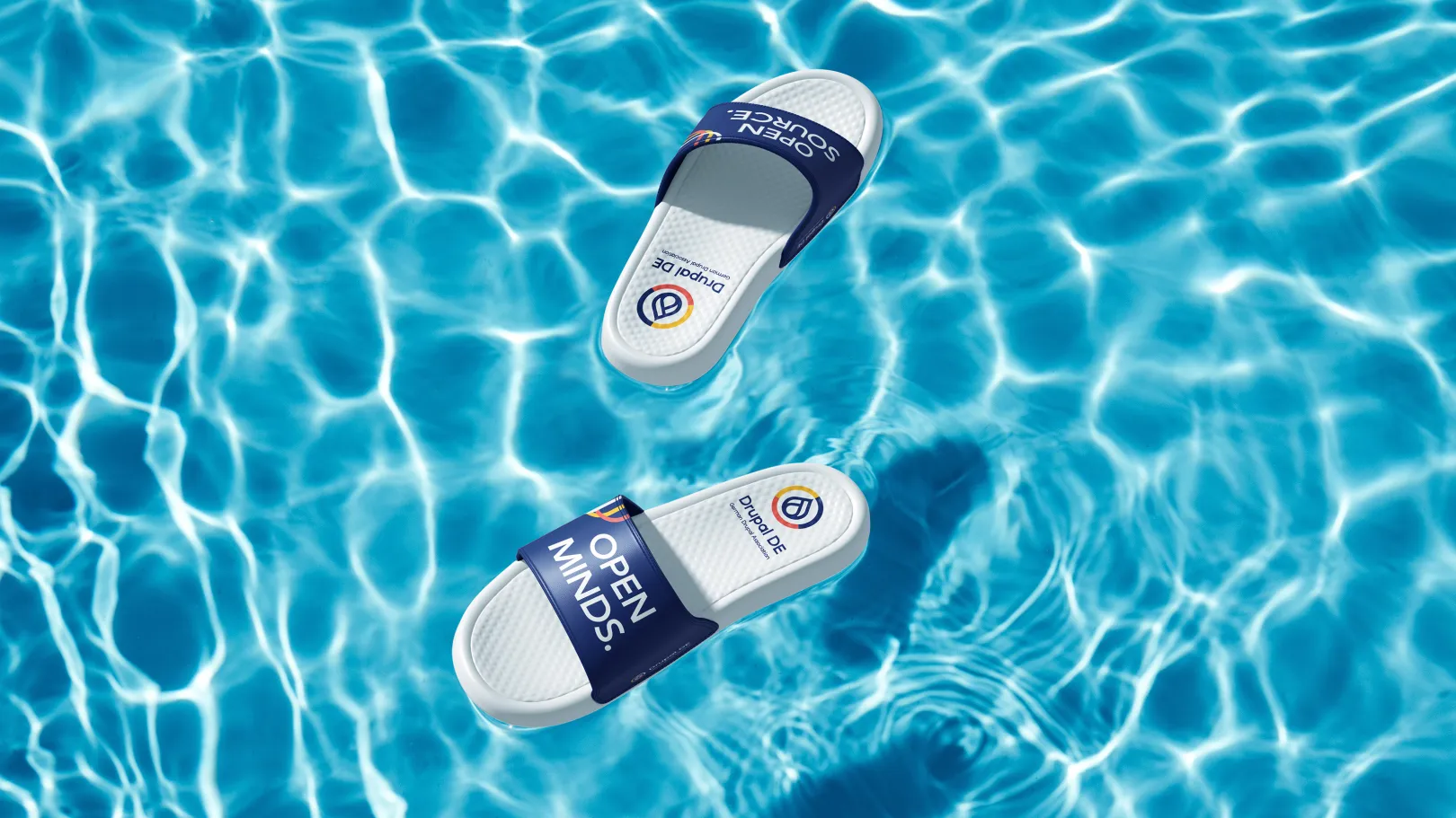 White sandals float on the turquoise pool water