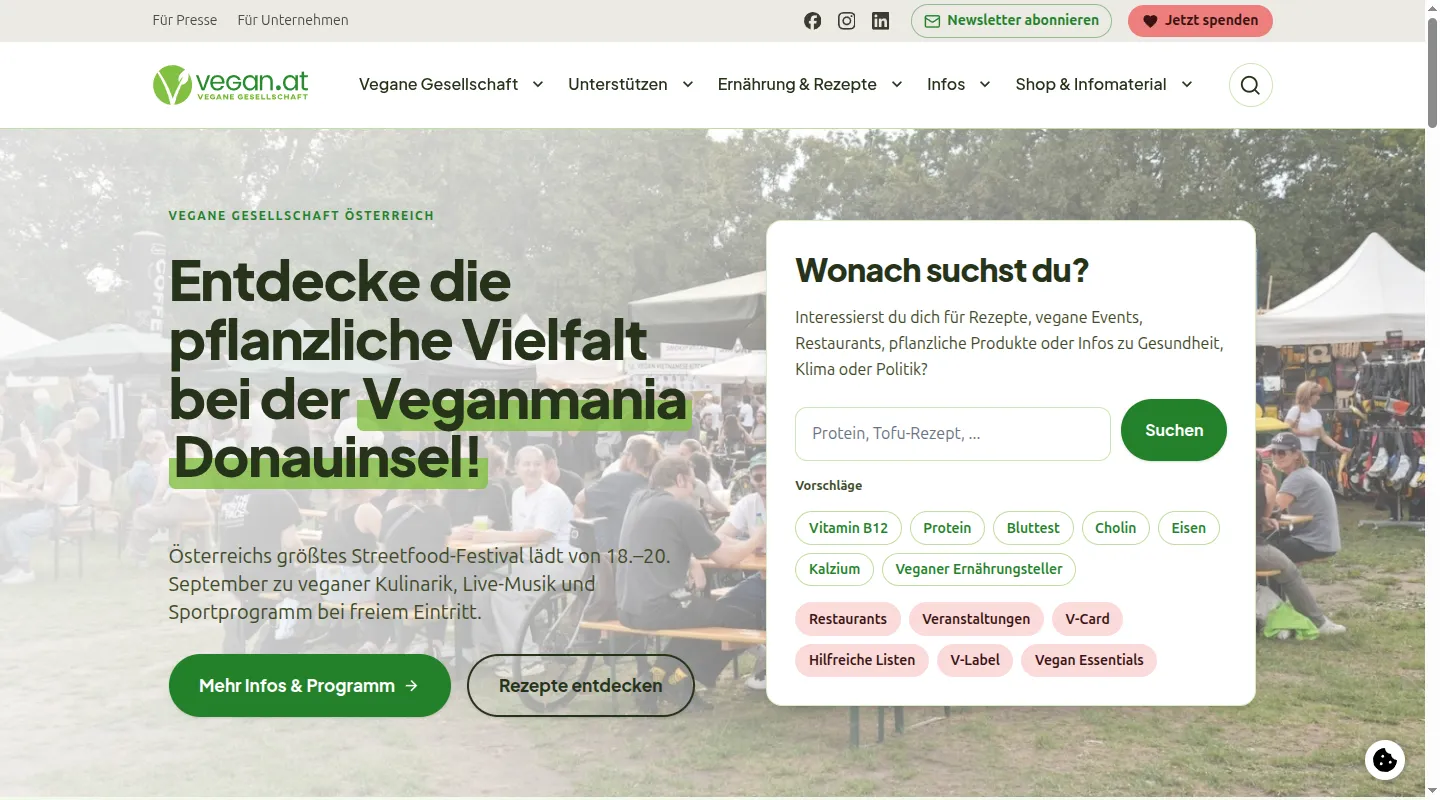 Homepage of vegan.at after the relaunch, desktop viewport: main navigation, hero for the Veganmania Donauinsel festival with a photo of visitors, and a search box "Wonach suchst du?" with suggested topics