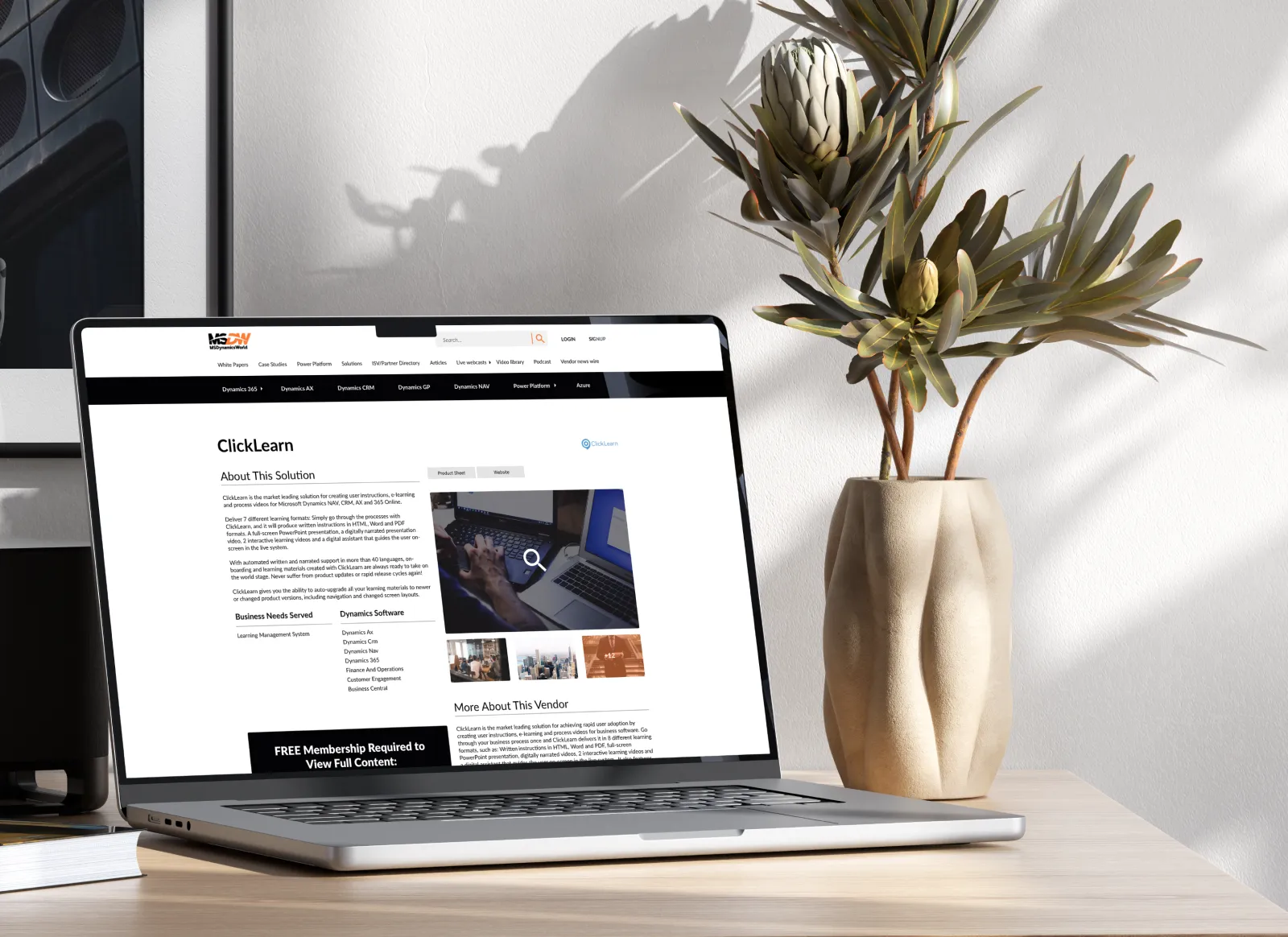 A laptop on a desk with a plant and a picture, showcasing customizable content on the MSDW website.