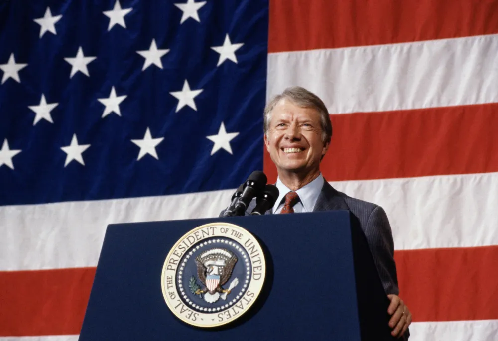 President Jimmy Carter at podium american flag