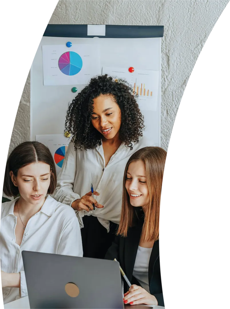 three women meeting around a laptop