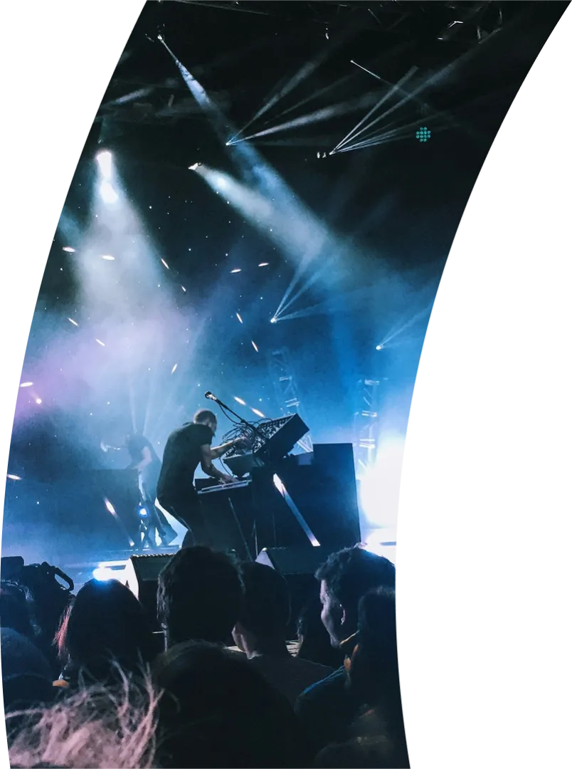 Man playing keyboards on stage at a concert