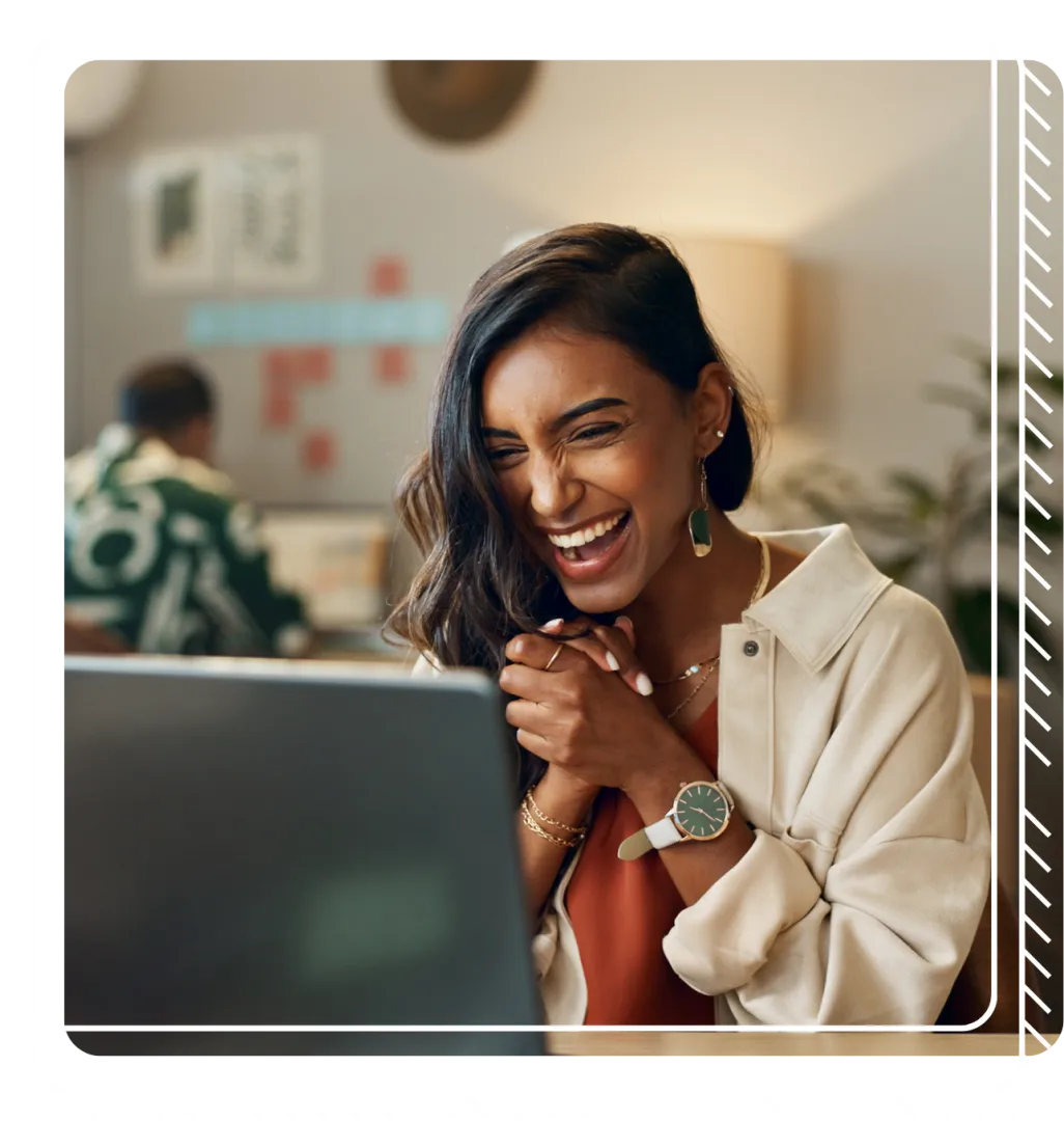Woman smiles while using her laptop