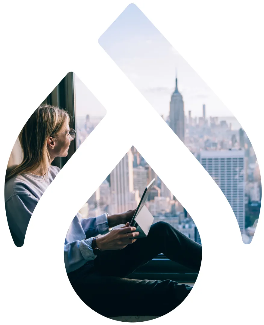 woman looking towards New York City skyline from a hotel room