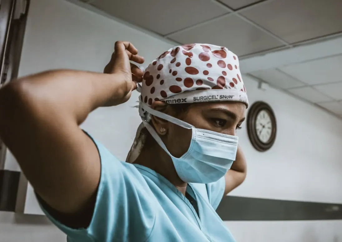 Healthcare worker putting on protective clothing