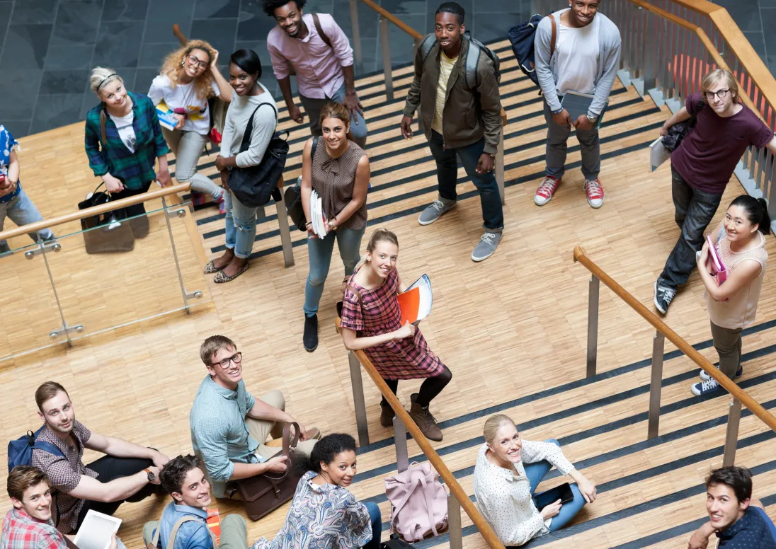 University students stand on steps