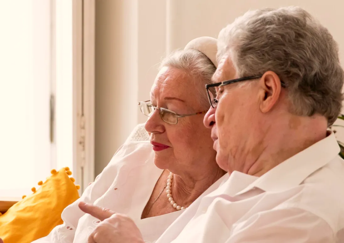 Elderly couple using a computer together