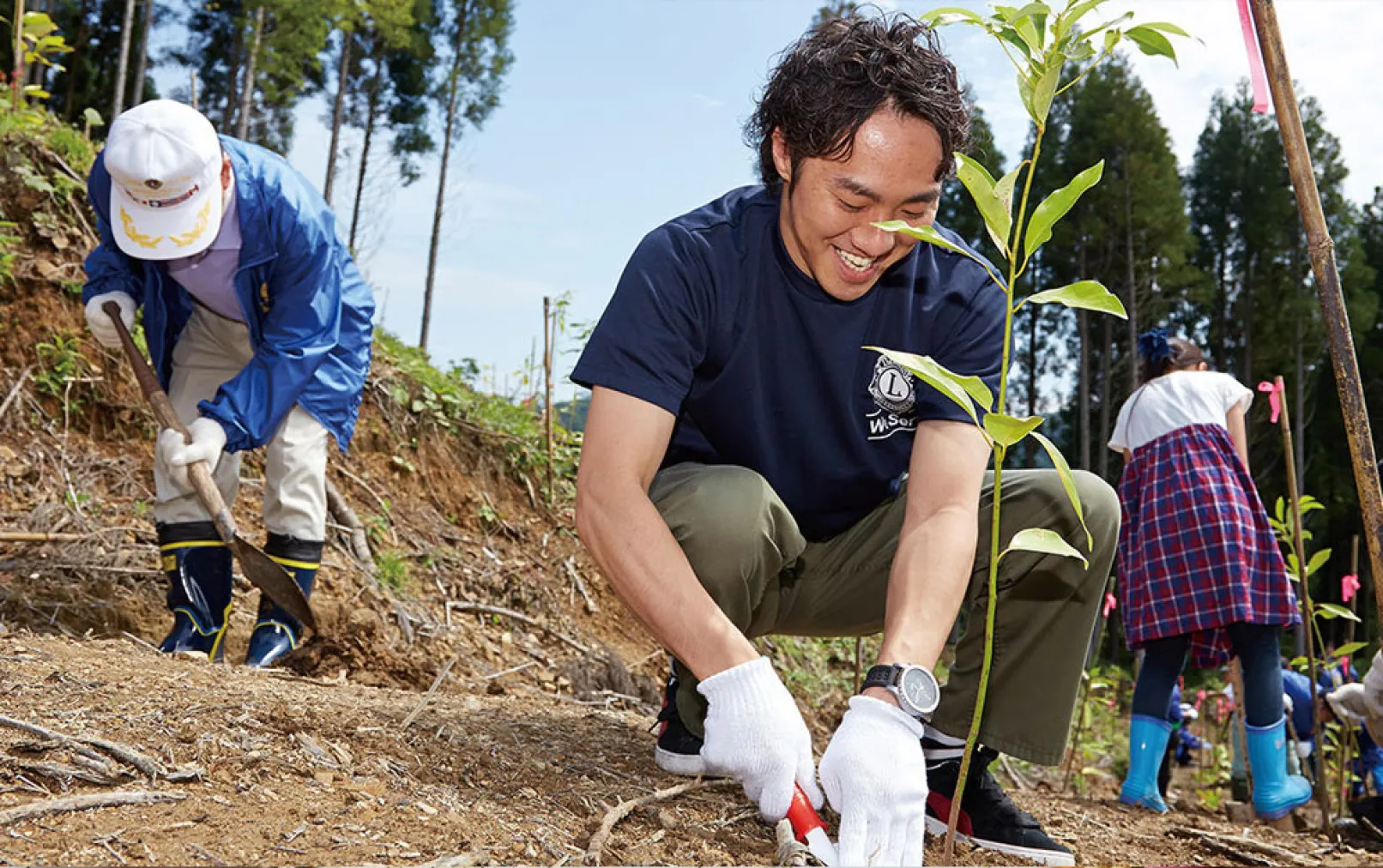 volunteers planting in a field