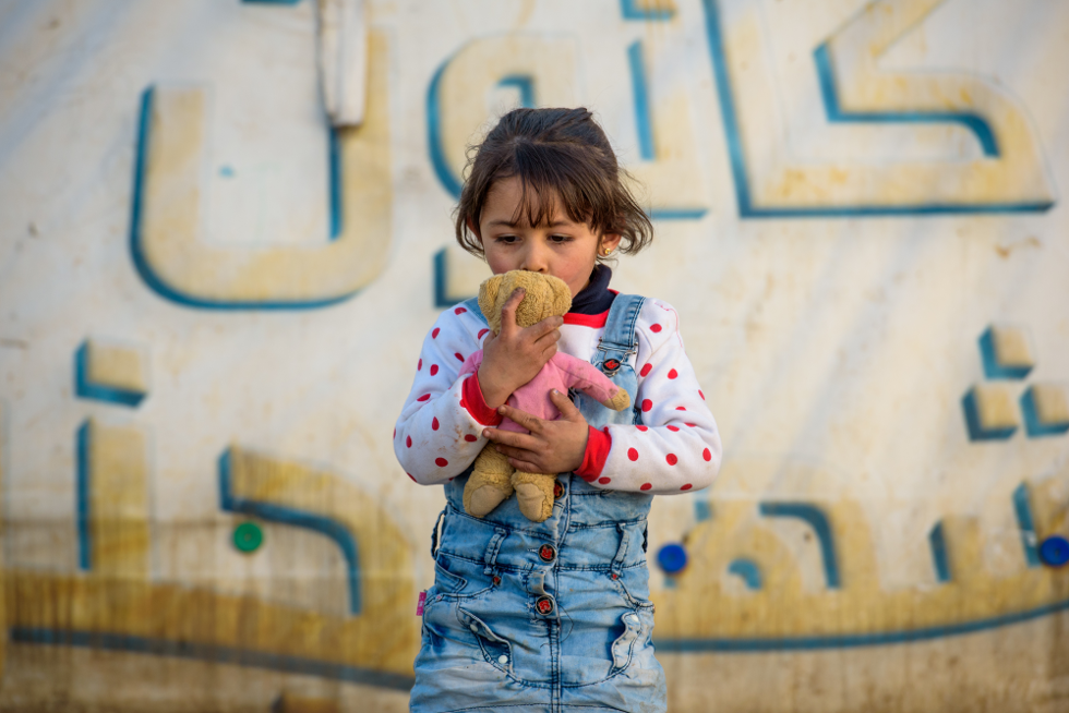girl kissing teddy bear
